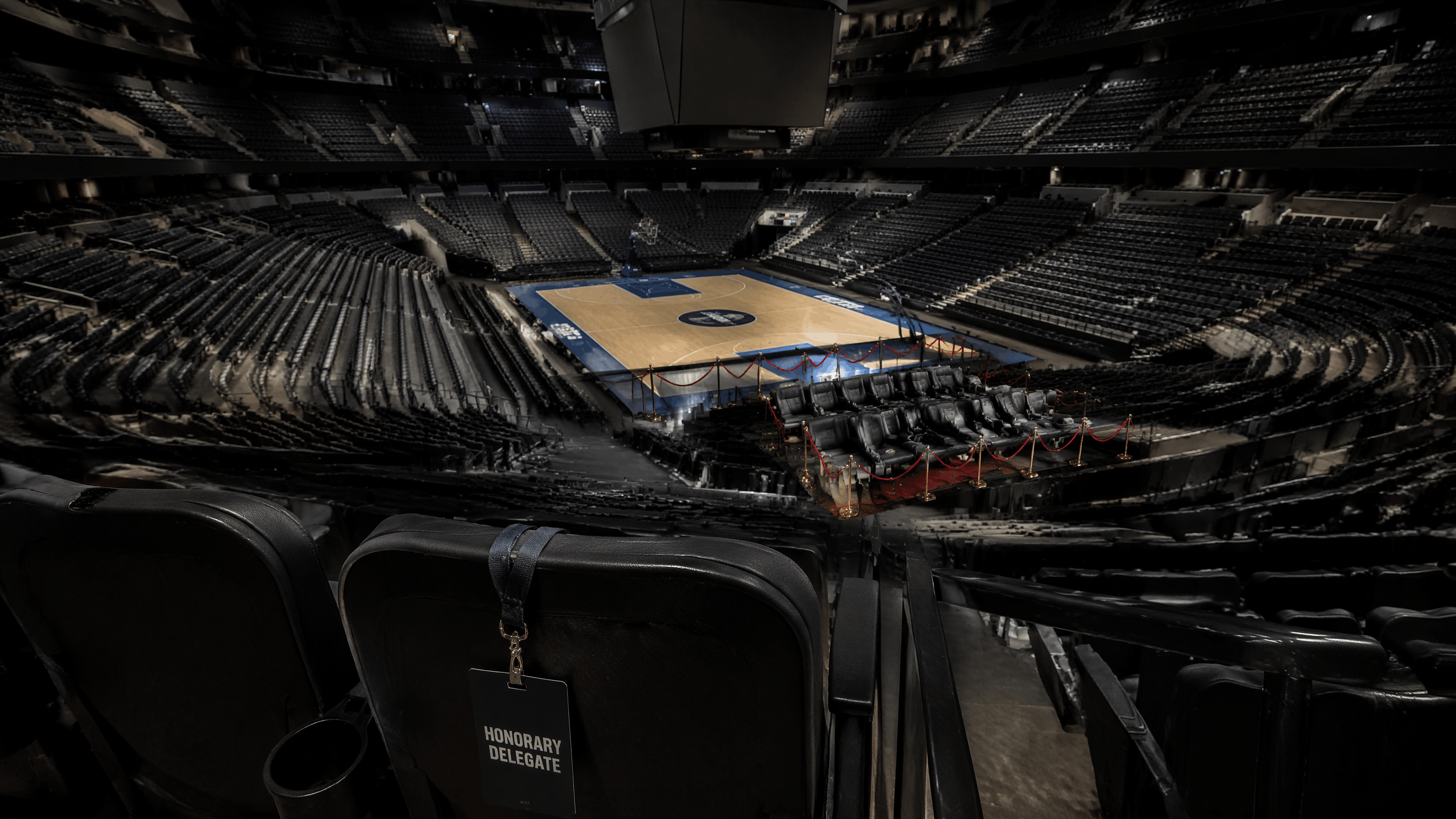 Empty arena with roped-off VIP seating